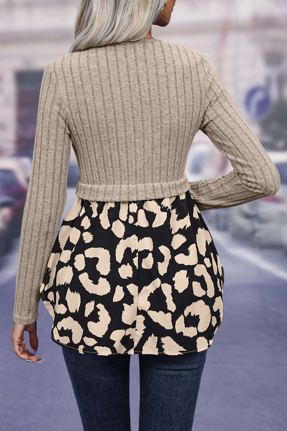 Beige ribbed knit peplum blouse with black leopard print bottom and long sleeves.