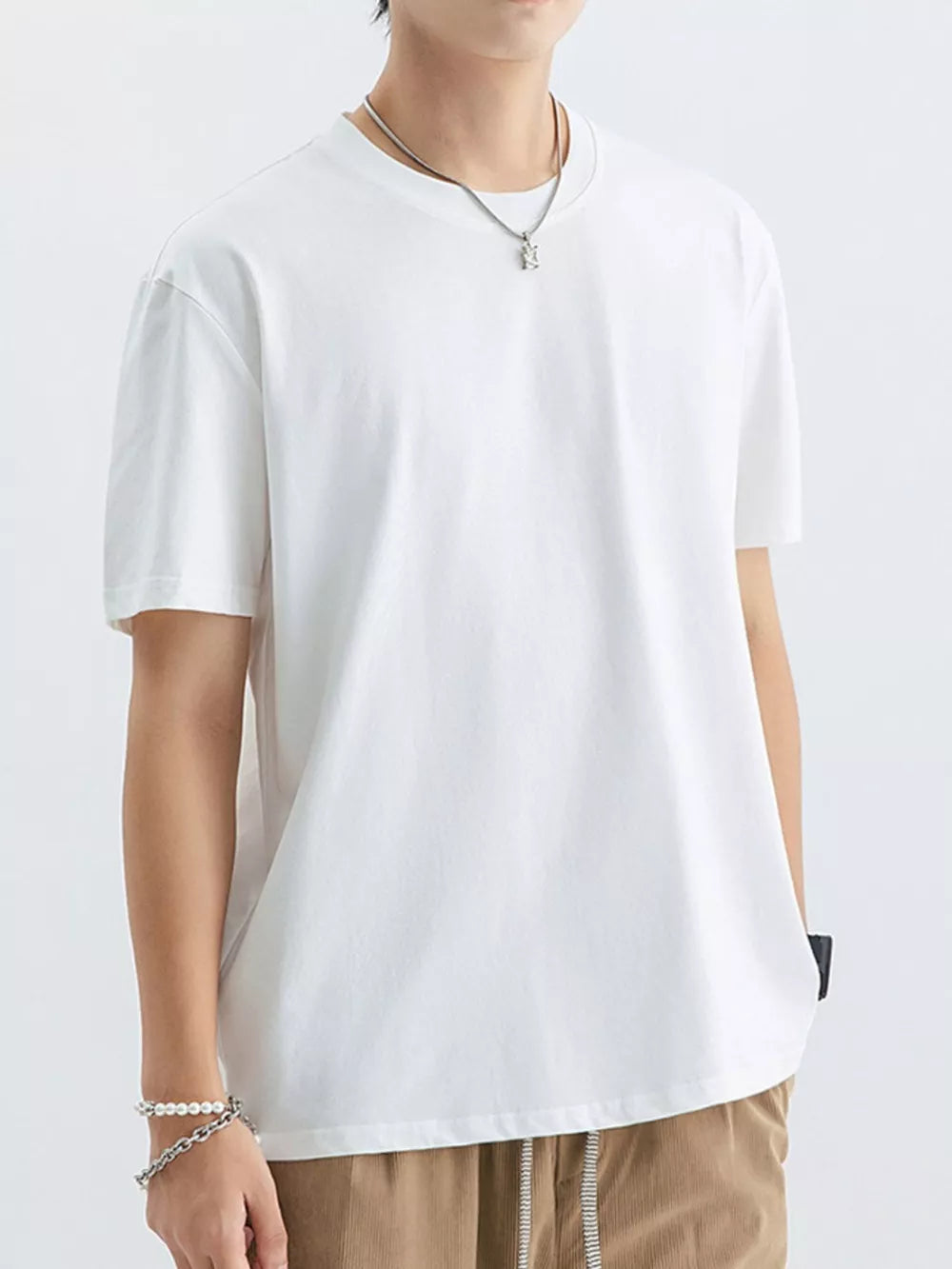 White cotton crew neck t-shirt with short sleeves and a relaxed fit.