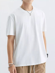 White cotton crew neck t-shirt with short sleeves and a relaxed fit.