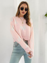 Blush pink distressed knit cropped sweater with white butterfly print and frayed hem.