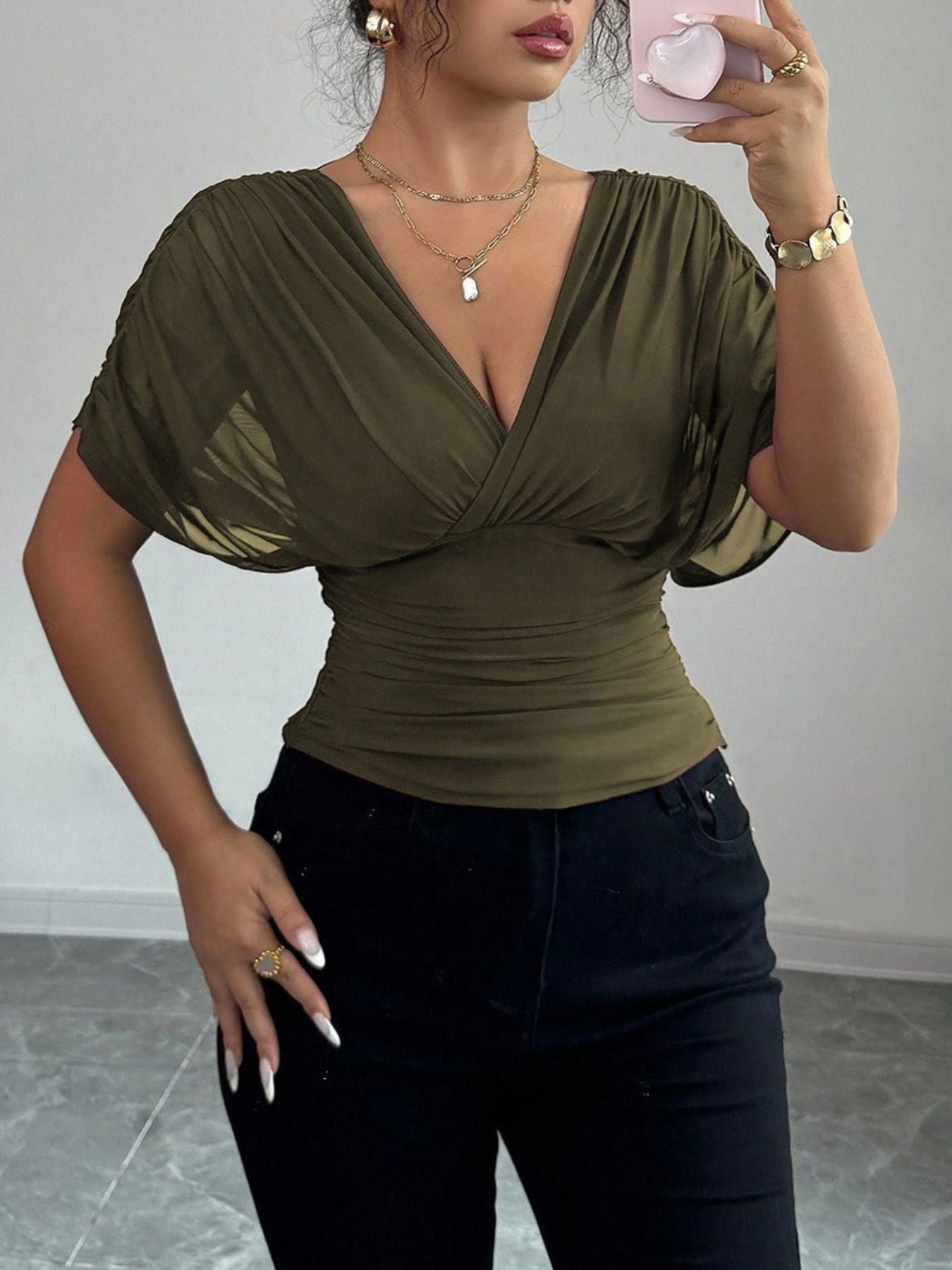Army green ruched surplice dolman sleeve top with V-neck and cinched waist.