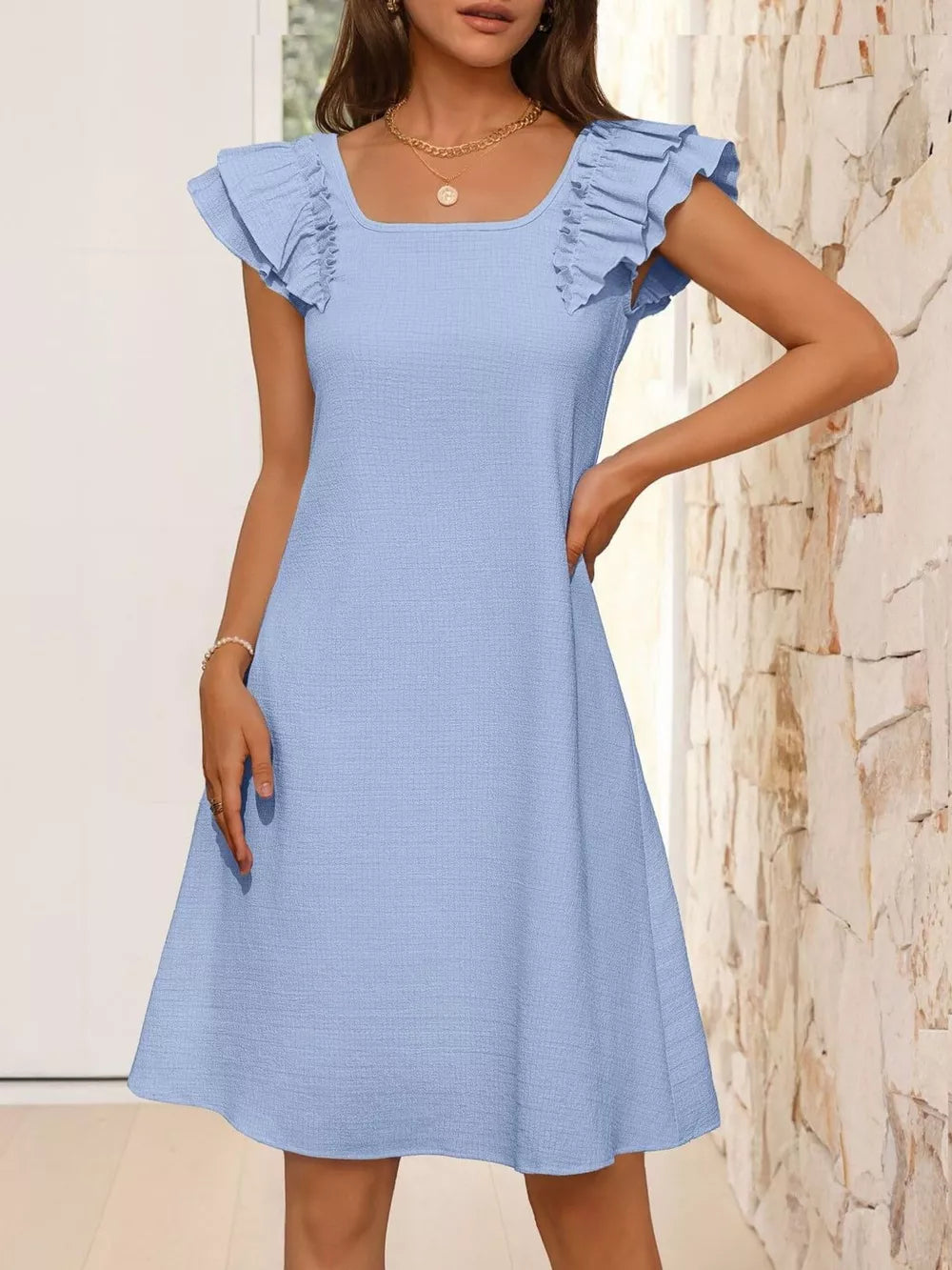 Light blue a-line dress with ruffled cap sleeves and square neckline.