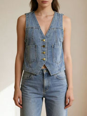 Light blue denim button-down vest with brass buttons and cropped length