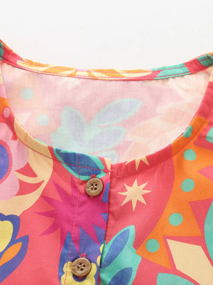 Toddler button-down dress with vibrant floral print and cotton blend fabric.