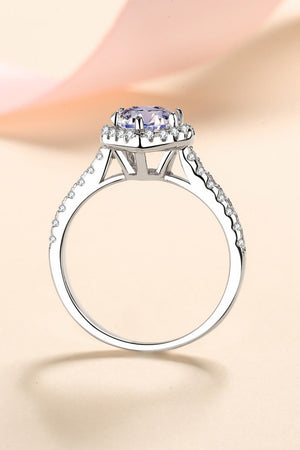 Silver ring with a heart-cut diamond halo and pavé band.