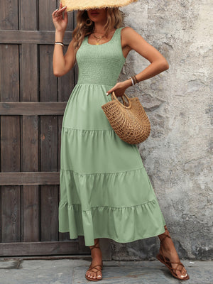 Light green smocked bodice tiered maxi dress with square neckline and sleeveless design.