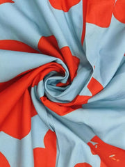 Maxi dress fabric with vibrant red floral print on light blue.