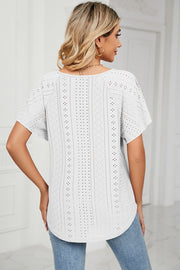 White eyelet blouse with flutter sleeves and scoop neck.