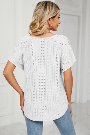 White eyelet blouse with flutter sleeves and scoop neck.