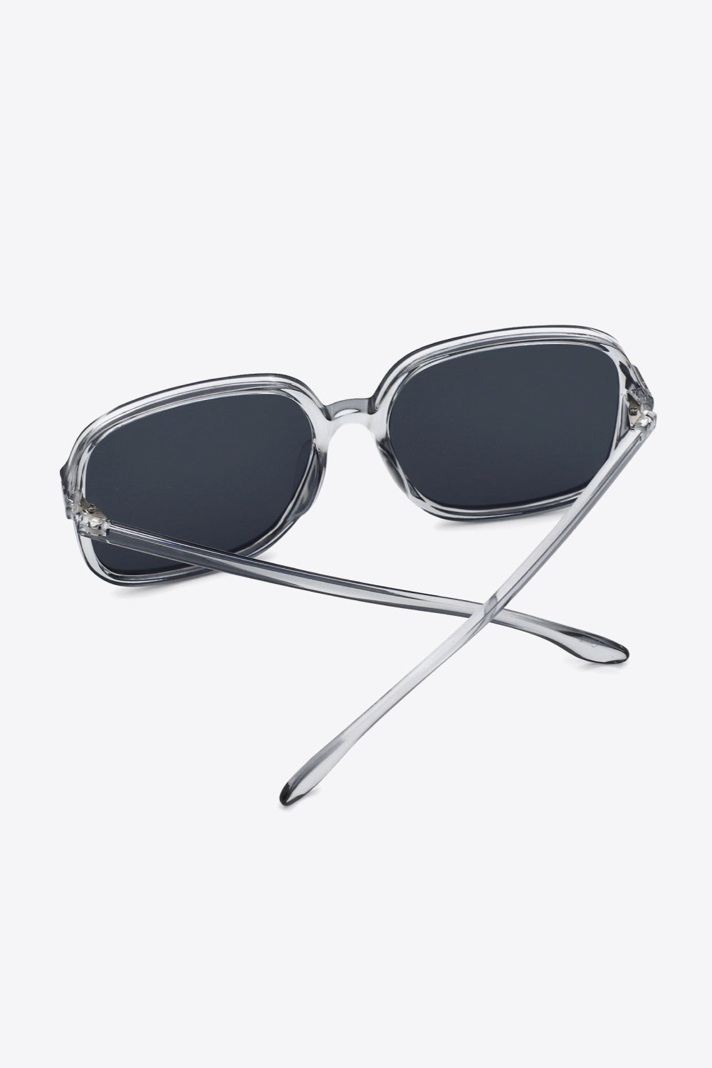 Retro square frame sunglasses with clear frames and dark lenses.