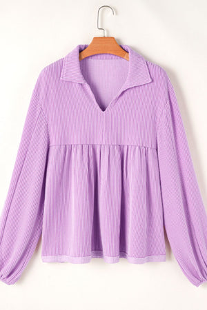 Lilac textured blouse with gathered yoke, collar, and long sleeves.