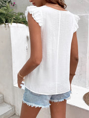 White embroidered trim flutter sleeve blouse with textured fabric.