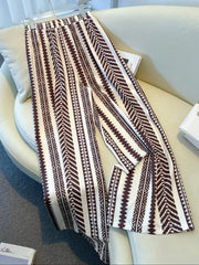 Maternity wide-leg pants in white with a brown geometric chevron print and bow detail.
