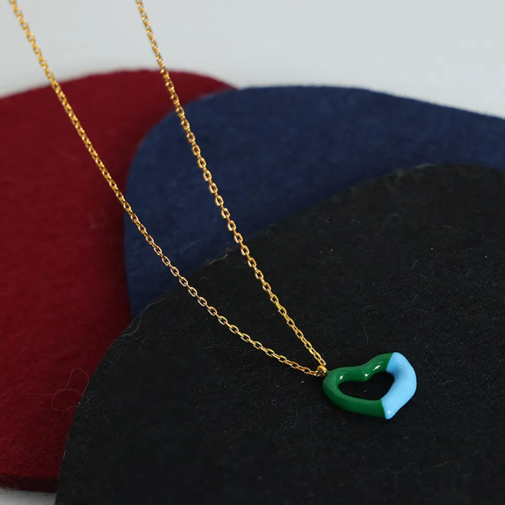 Two-tone heart enamel necklace with gold chain.