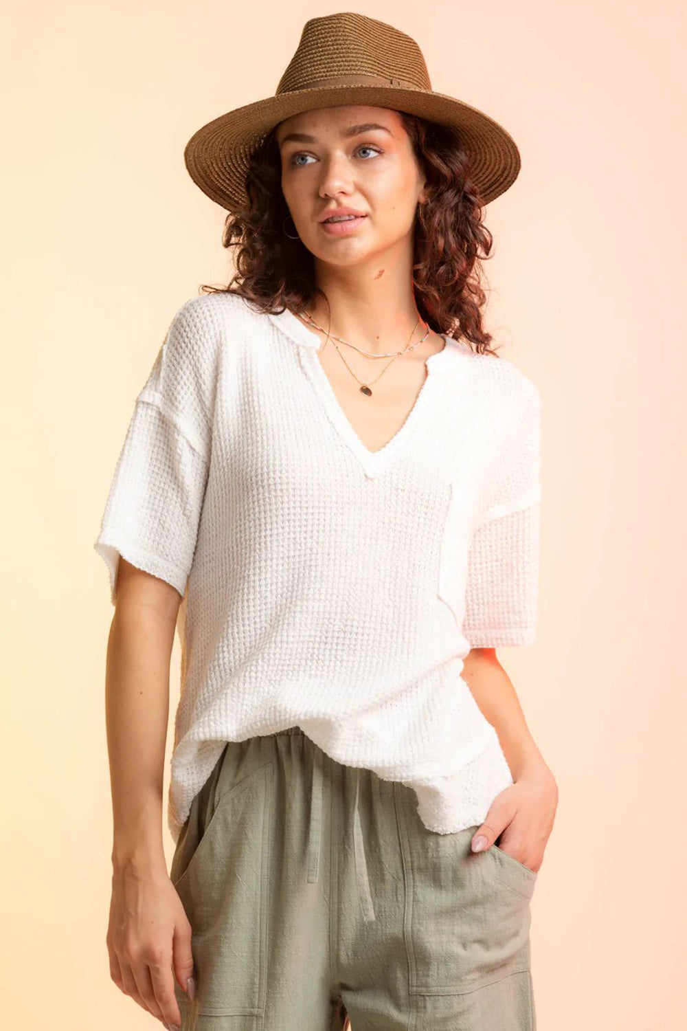 White waffle knit v-neck top with short sleeves and a chest pocket