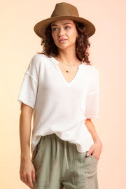 White waffle knit v-neck top with short sleeves and a chest pocket