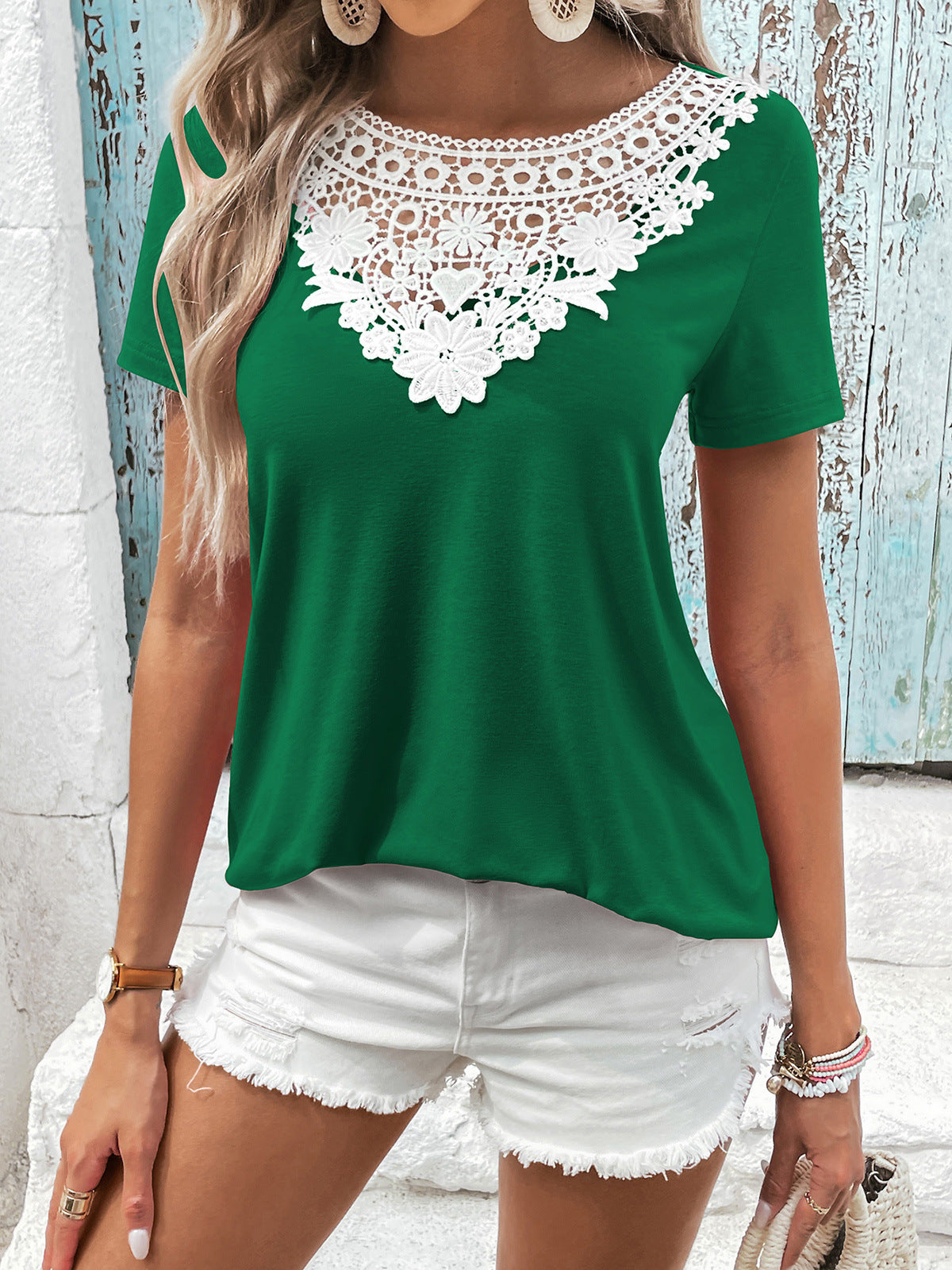 Green t-shirt with short sleeves and a white floral lace yoke detail.