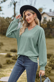 Sage textured cable knit v-neck sweater with balloon sleeves.