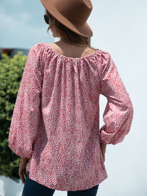 Off-the-shoulder red spotted print blouson top with balloon sleeves.