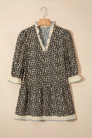 Leopard print mini dress with ruffled neckline and cuffs, striped trim, and tiered skirt.
