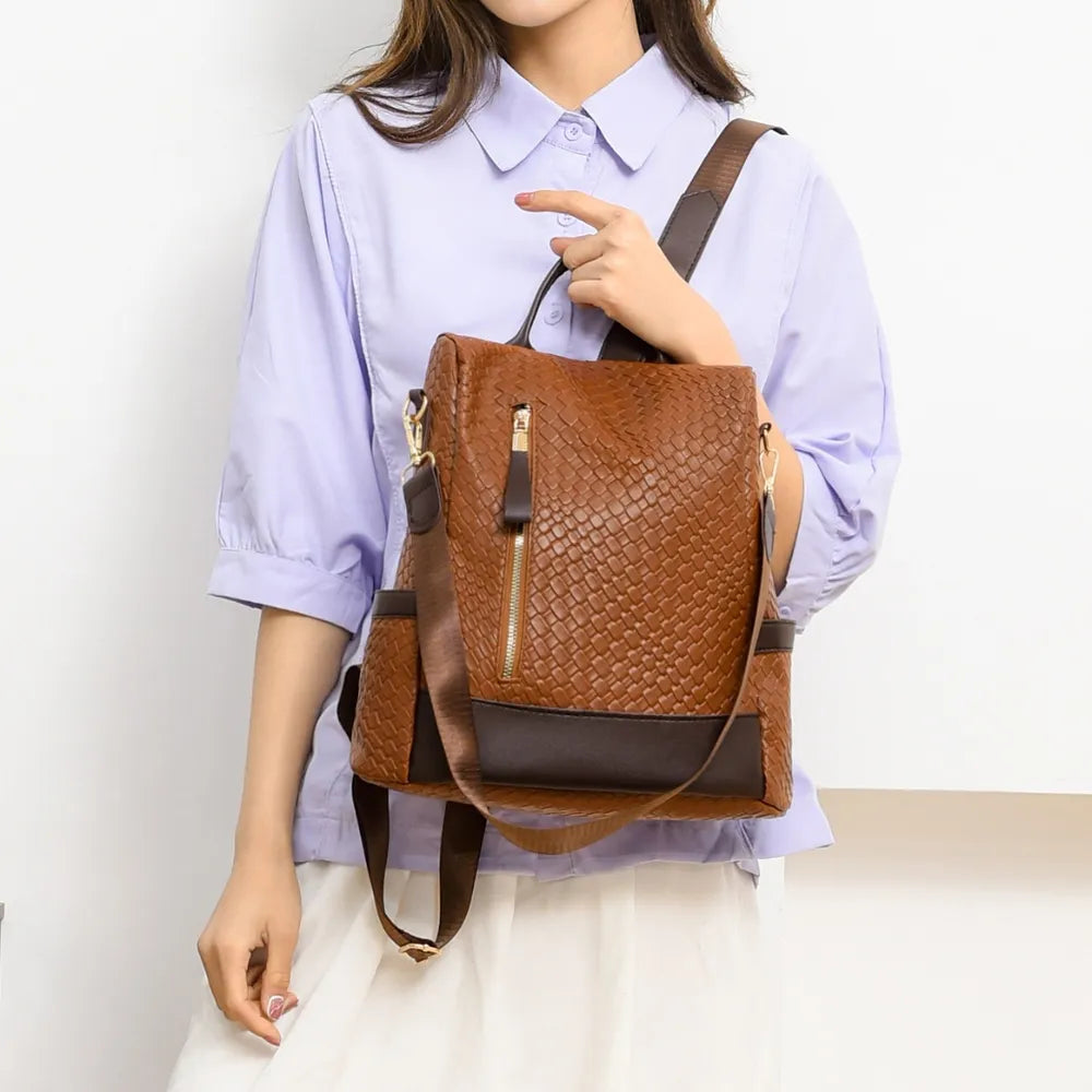 Brown woven faux leather convertible backpack with gold zipper detail