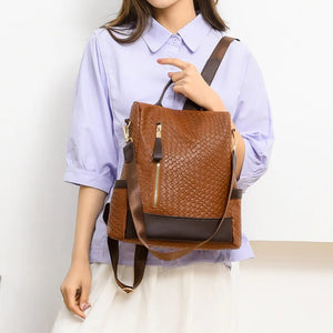 Brown woven faux leather convertible backpack with gold zipper detail
