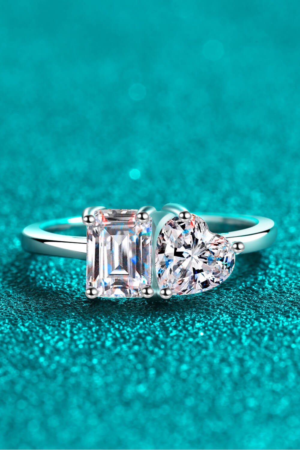 Silver ring with emerald-cut and heart-cut moissanite stones