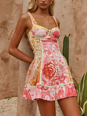 Floral lace-up mini dress with sweetheart neckline and bright paisley print.