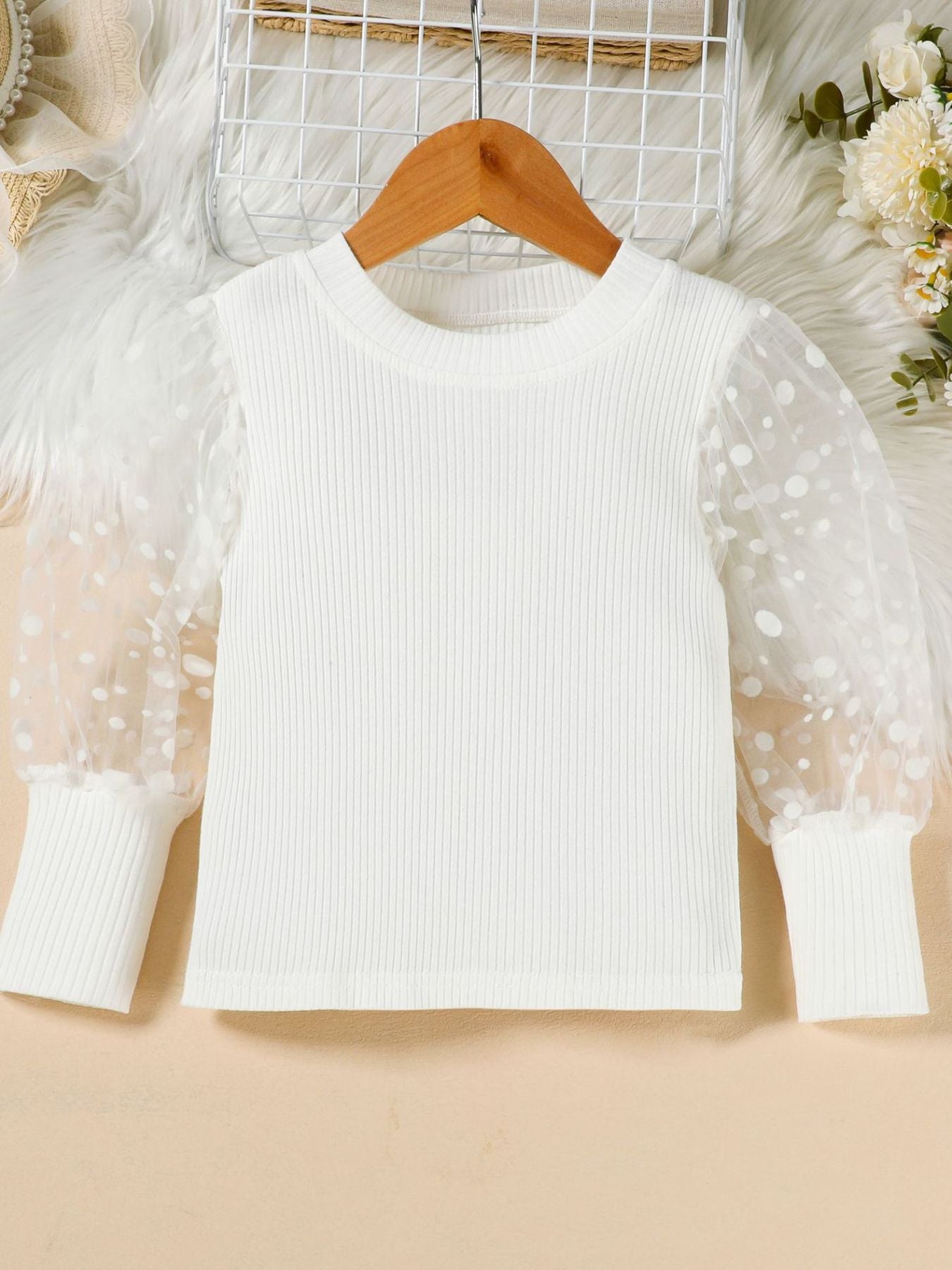 White toddler top with polka dot sheer puff sleeves and ribbed knit body