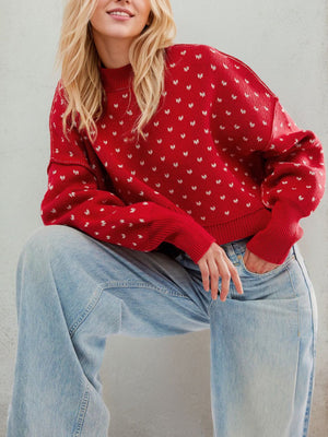 Dotted knit cropped crewneck sweater in Deep Red with a mock neck and long sleeves.