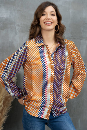 Geometric print blouson sleeve blouse in orange with blue and white polka dots and stripes.