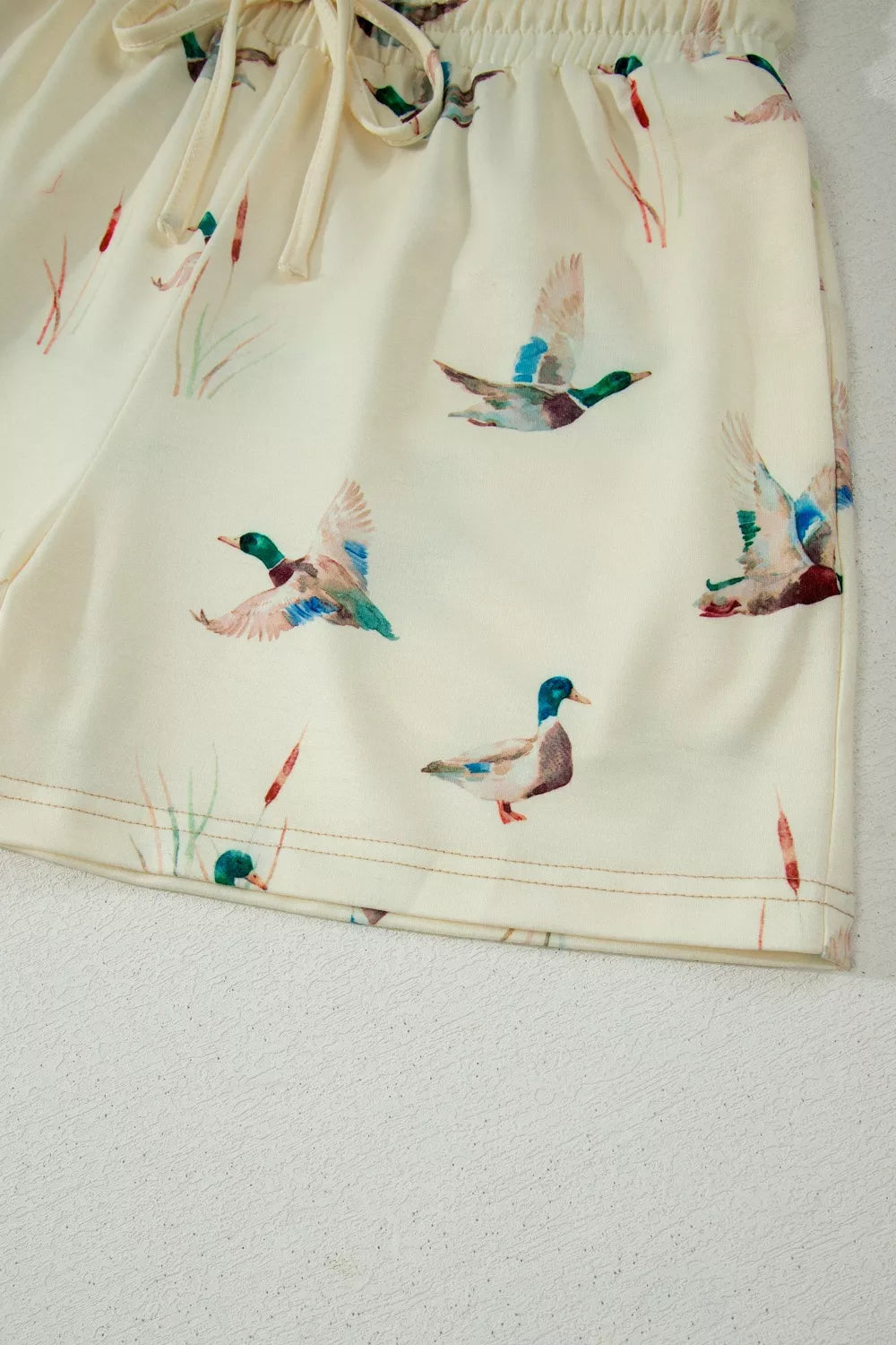 Beige pajama shorts with mallard duck print and drawstring waist.