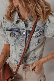 Cropped denim bolero jacket in medium wash with puff sleeves and distressed details.