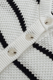 White and black stripe knit pullover sweater with button detail.
