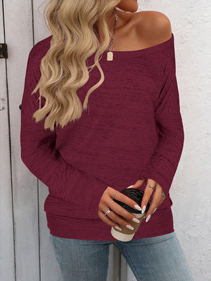 Burgundy heathered knit off-the-shoulder top with long sleeves.