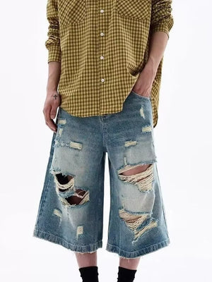 Distressed blue denim wide-leg shorts for men with ripped details.