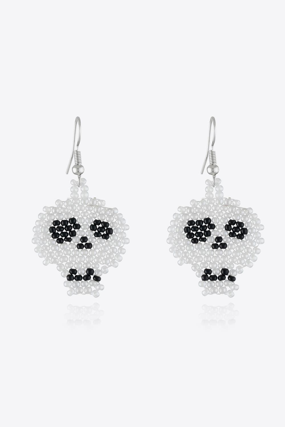 Beaded Skull earrings in white and black, featuring beaded eyes and mouth detail.
