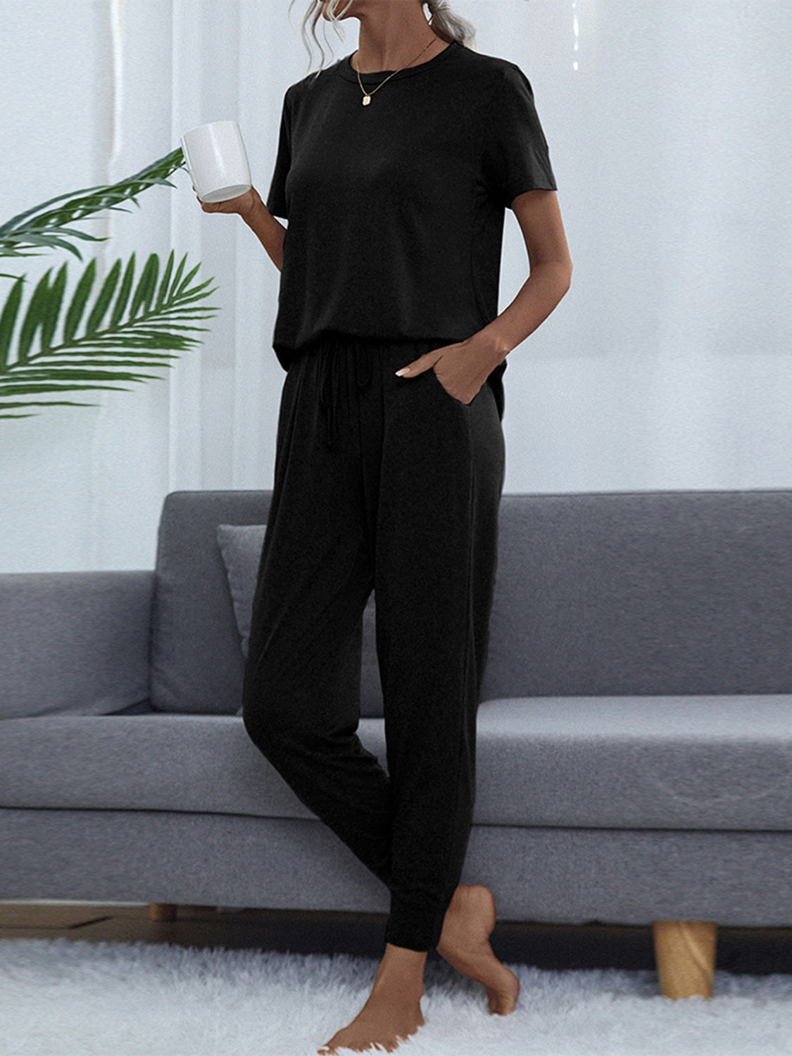 Black relaxed-fit tee and jogger set with drawstring waist and pockets.