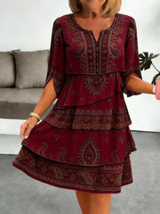 Burgundy paisley print tiered mini dress with split sleeves and V-neck.