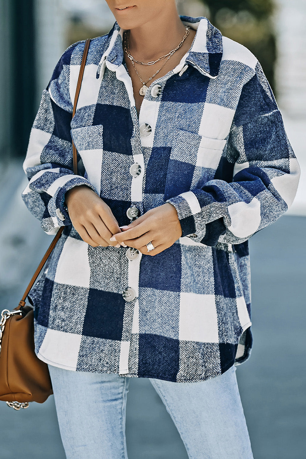 Oversized blue and white checkered shacket with button-down front and patch pocket.