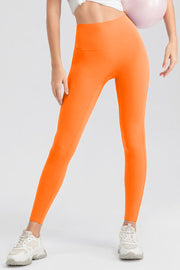 Orange high-waist performance leggings with sculpting seams