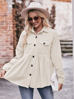 Beige corduroy peplum shirt jacket with buttoned front and chest pockets.