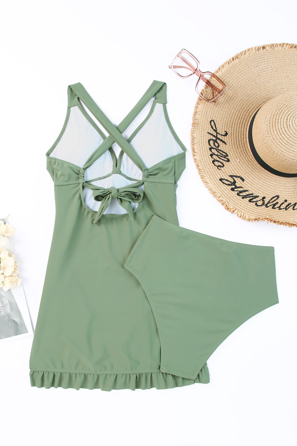 Sage ruched halter swim dress with crisscross back tie and ruffled hem.