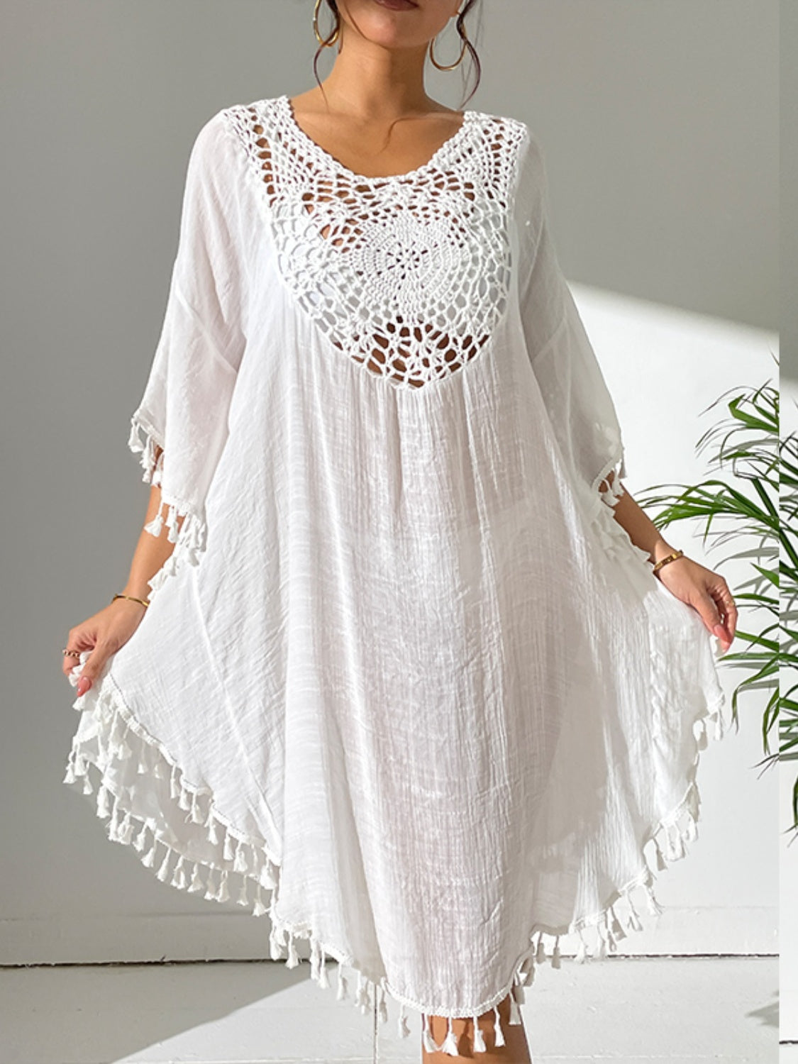 White crochet yoke tassel kaftan dress with a relaxed fit and boho style.