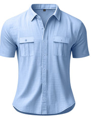 Light blue short sleeve button-down shirt with two chest pockets and a collared neckline.
