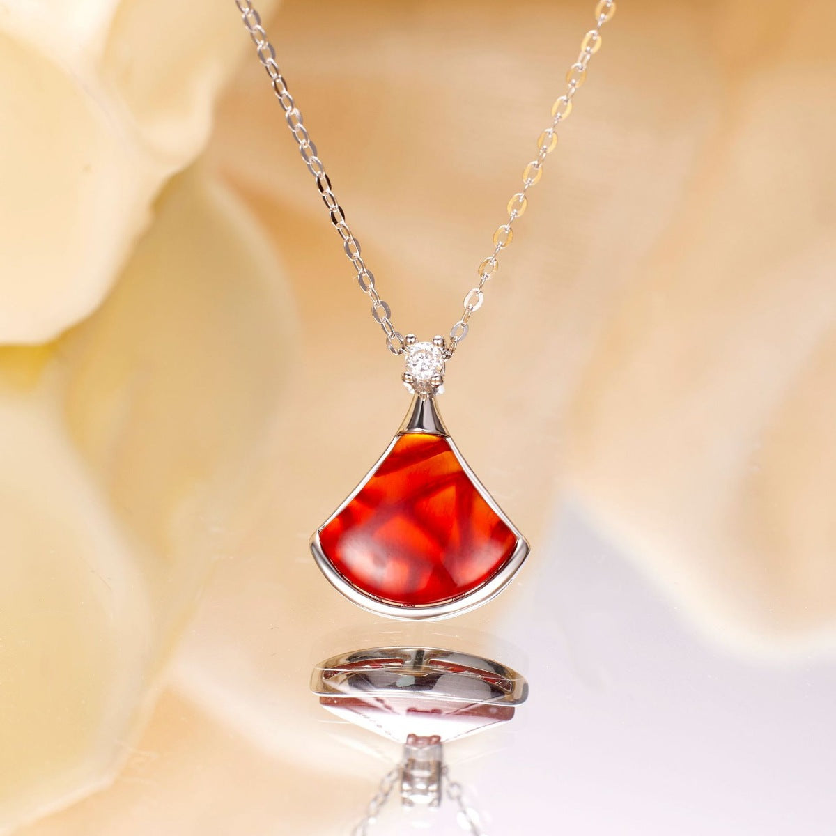 Elegant fan-shaped red agate pendant necklace with diamond accent on sterling silver chain