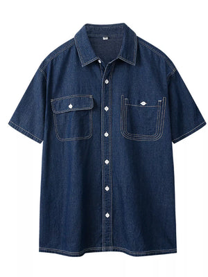 Dark blue denim button-up shirt with short sleeves, two chest pockets, and white contrast stitching.