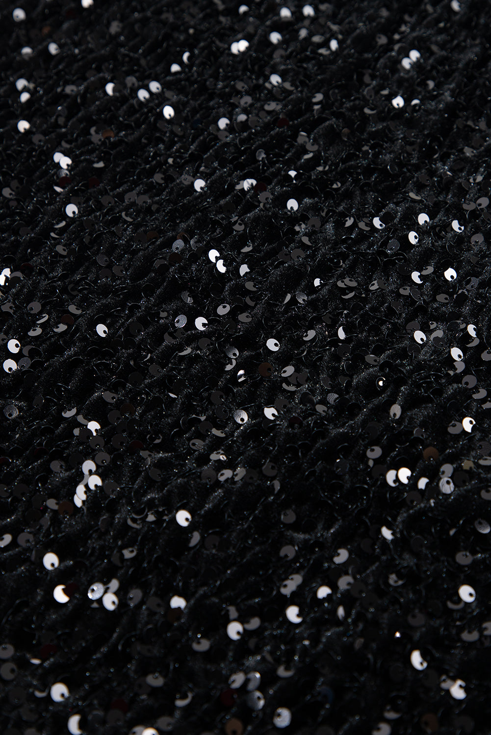 Black sequin mini skirt with body-hugging fit and textured fabric.