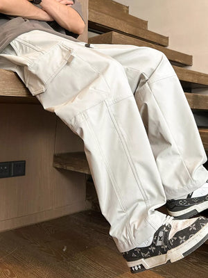 Oversized khaki cargo pants with adjustable drawstring and multiple pockets.