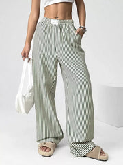 Green striped high-waisted wide-leg pants with drawstring detail.